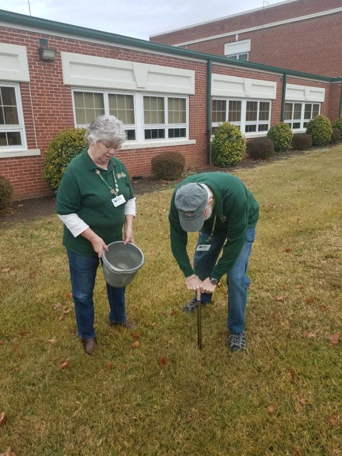 Master Gardeners Rich Howell and Sharon Rodriguez demonstrate how to take a soil sample